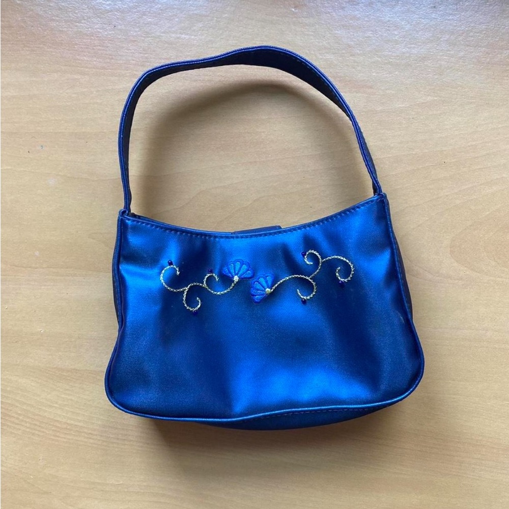 Small blue handbag with embroidered flower details